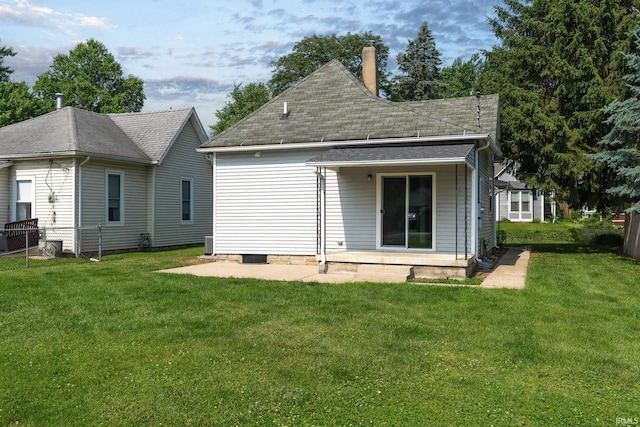 115 S 27th St, Lafayette, IN 47904 - rear view of house featuring a patio, a lawn, a chimney, and roof with shingles