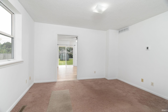 115 S 27th St, Lafayette, IN 47904 - spare room featuring carpet floors, a ceiling fan, and a textured ceiling