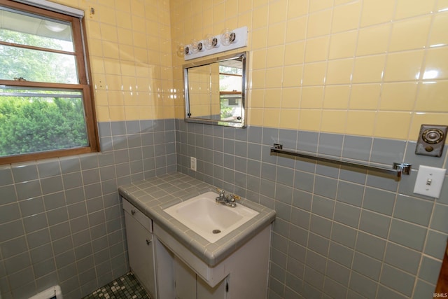 18655 Cleveland Rd, South Bend, IN 46637 - bathroom with tile walls, vanity, and healthy amount of natural light