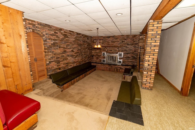 18655 Cleveland Rd, South Bend, IN 46637 - unfurnished living room with carpet flooring, a drop ceiling, brick wall, and recessed lighting