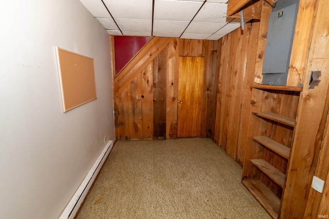 18655 Cleveland Rd, South Bend, IN 46637 - finished basement featuring a baseboard heating unit, wood walls, a paneled ceiling, and carpet