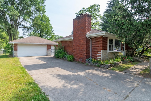 18655 Cleveland Rd, South Bend, IN 46637 - view of side of property featuring a chimney, stone siding, a detached garage, roof with shingles, and a lawn
