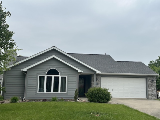 2203 Glen Hollow Dr, Auburn, IN 46706 - ranch-style home featuring concrete driveway, a garage, roof with shingles, and a front yard