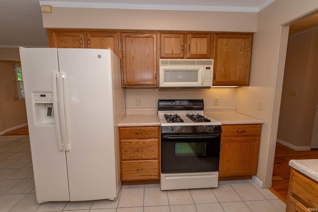 18633 Cleveland Rd, South Bend, IN 46637 - kitchen featuring white appliances, brown cabinets, light countertops, and ornamental molding