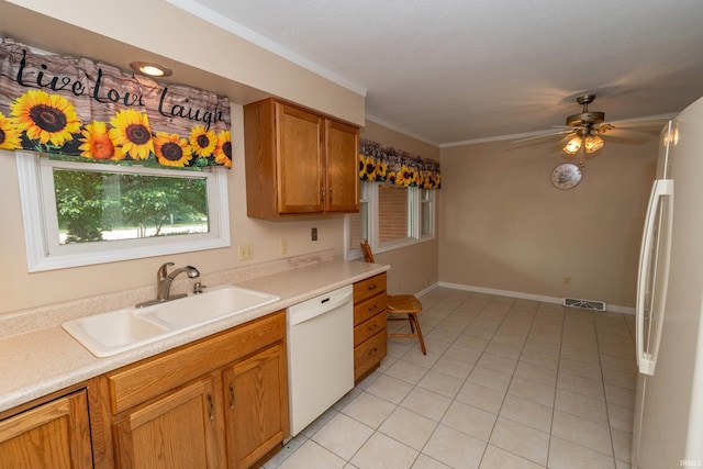 18633 Cleveland Rd, South Bend, IN 46637 - kitchen featuring white appliances, light tile patterned flooring, light countertops, ceiling fan, and ornamental molding