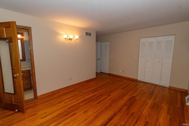 18633 Cleveland Rd, South Bend, IN 46637 - unfurnished bedroom featuring wood finished floors and ensuite bath