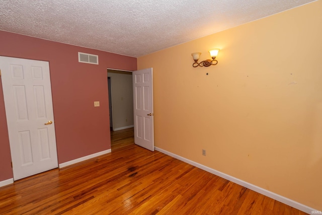 18633 Cleveland Rd, South Bend, IN 46637 - unfurnished bedroom featuring a textured ceiling and wood finished floors