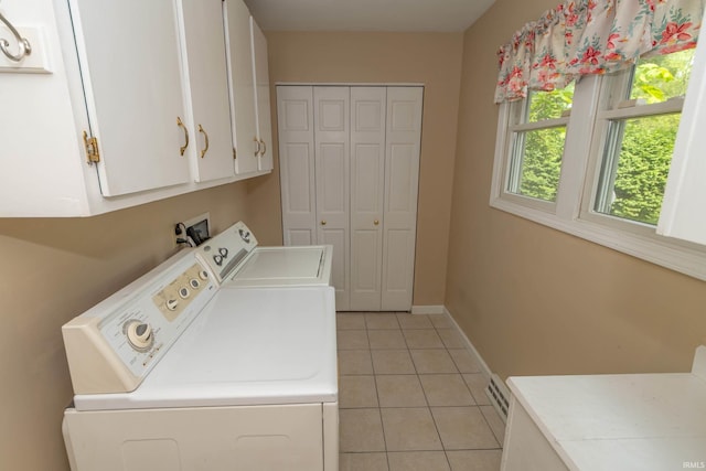 18633 Cleveland Rd, South Bend, IN 46637 - washroom featuring cabinet space, washer and dryer, and light tile patterned flooring