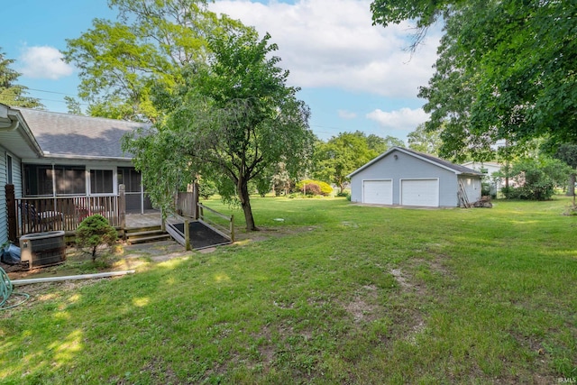 18633 Cleveland Rd, South Bend, IN 46637 - view of green lawn featuring a sunroom, a garage, and an outbuilding