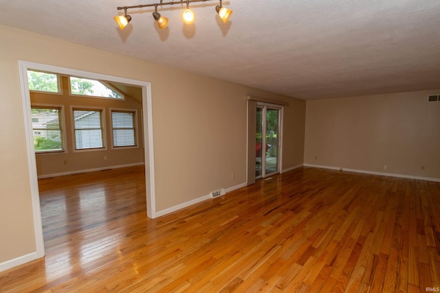 18633 Cleveland Rd, South Bend, IN 46637 - unfurnished room featuring light wood-style floors and a textured ceiling