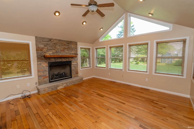 18633 Cleveland Rd, South Bend, IN 46637 - unfurnished living room featuring a ceiling fan, light wood-style floors, a stone fireplace, vaulted ceiling, and recessed lighting