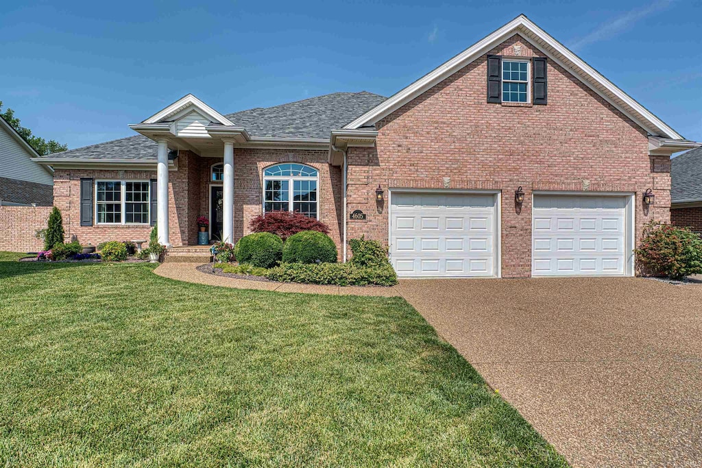 4605 Fieldcrest Place Cir, Newburgh, IN 47630 - view of front of property with concrete driveway, brick siding, a shingled roof, and a front lawn