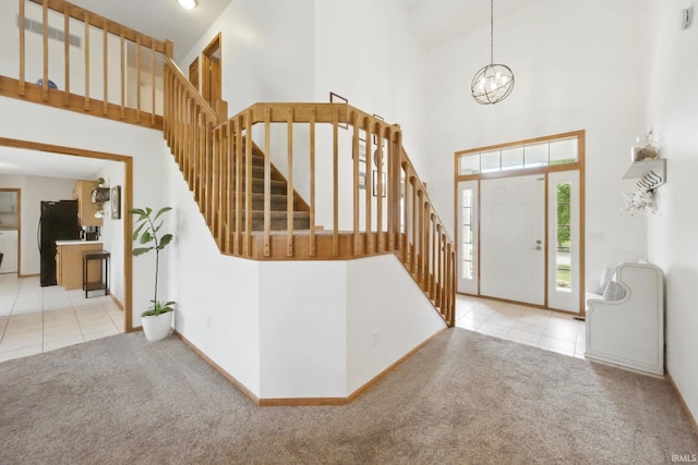 14628 Firethorne Path, Fort Wayne, IN 46814 - tiled entrance foyer featuring carpet floors, a high ceiling, stairway, and a chandelier