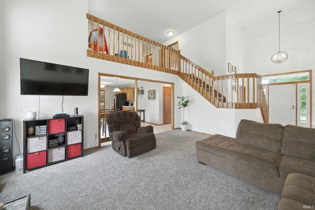 14628 Firethorne Path, Fort Wayne, IN 46814 - living area featuring a high ceiling, carpet floors, stairs, and a chandelier