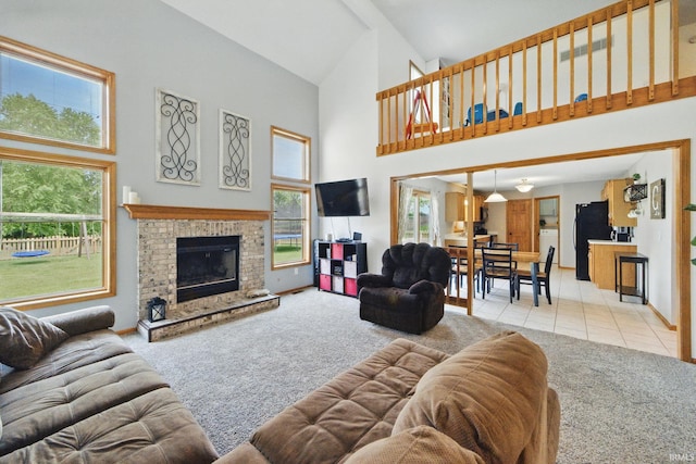 14628 Firethorne Path, Fort Wayne, IN 46814 - living room with carpet flooring, high vaulted ceiling, healthy amount of natural light, a brick fireplace, and tile patterned flooring