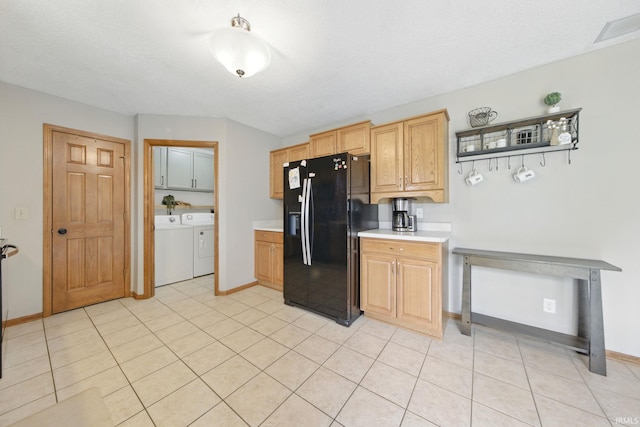 14628 Firethorne Path, Fort Wayne, IN 46814 - kitchen with black fridge, washer and clothes dryer, light countertops, and light tile patterned floors
