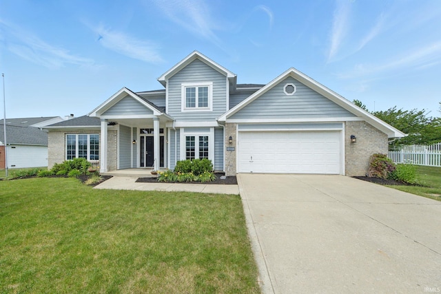 14628 Firethorne Path, Fort Wayne, IN 46814 - traditional-style house with a garage, concrete driveway, brick siding, and covered porch