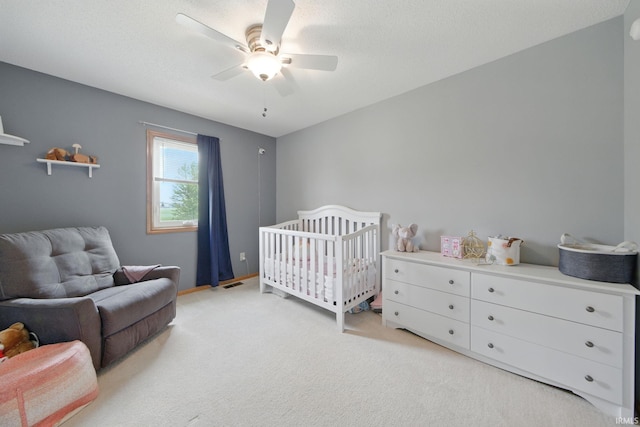 14628 Firethorne Path, Fort Wayne, IN 46814 - bedroom featuring light colored carpet, a crib, and a ceiling fan