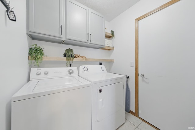 14628 Firethorne Path, Fort Wayne, IN 46814 - laundry room featuring washing machine and clothes dryer, cabinet space, and light tile patterned flooring