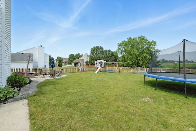 14628 Firethorne Path, Fort Wayne, IN 46814 - fenced backyard featuring a trampoline, a playground, and a patio