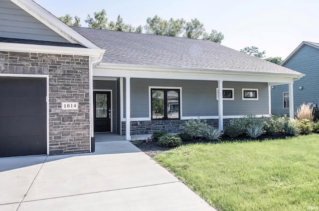 1014 Happy Hollow Rd, West Lafayette, IN 47906 - ranch-style home with an attached garage, stone siding, a front yard, covered porch, and a shingled roof