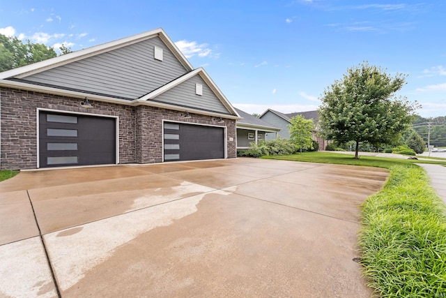 1014 Happy Hollow Rd, West Lafayette, IN 47906 - view of home's exterior with a garage, driveway, and brick siding