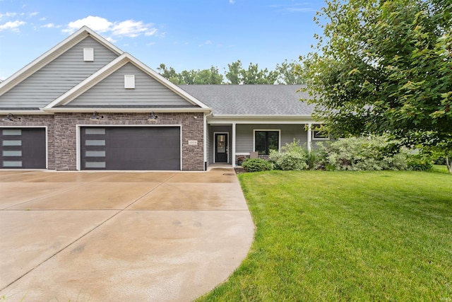 1014 Happy Hollow Rd, West Lafayette, IN 47906 - view of front facade with an attached garage, a front yard, concrete driveway, and brick siding