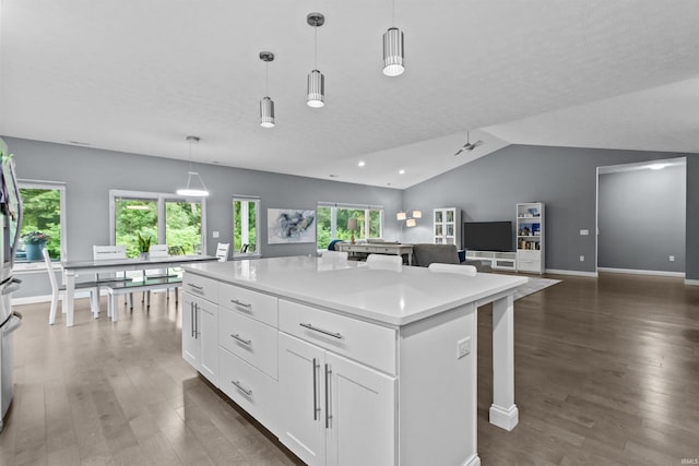1014 Happy Hollow Rd, West Lafayette, IN 47906 - kitchen with wood finished floors, white cabinets, lofted ceiling, a center island, and light countertops