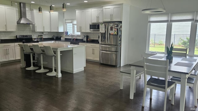 1014 Happy Hollow Rd, West Lafayette, IN 47906 - kitchen with stainless steel appliances, wall chimney range hood, dark wood-style floors, tasteful backsplash, and recessed lighting