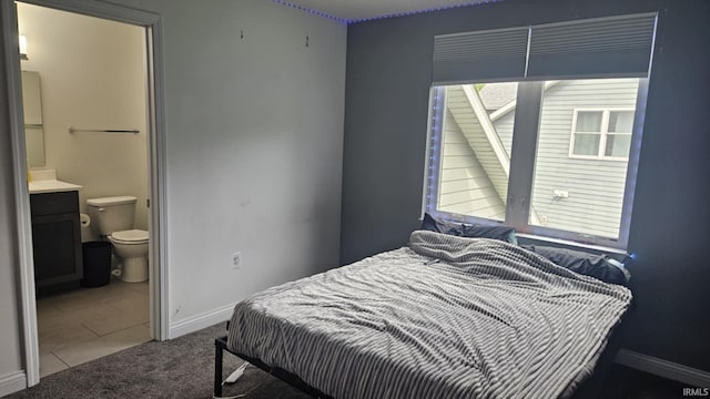 1014 Happy Hollow Rd, West Lafayette, IN 47906 - carpeted bedroom featuring ensuite bath and tile patterned floors