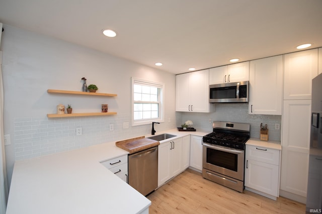1914 Bayberry Ln, West Lafayette, IN 47906 - kitchen with appliances with stainless steel finishes, light countertops, white cabinets, tasteful backsplash, and recessed lighting