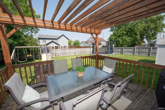 1914 Bayberry Ln, West Lafayette, IN 47906 - wooden deck featuring a trampoline, outdoor dining space, a playground, and a fenced backyard