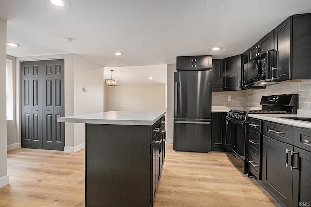 822 W Donaldson Ave, Mishawaka, IN 46545 - kitchen featuring black appliances, dark cabinets, light countertops, light wood-style floors, and recessed lighting