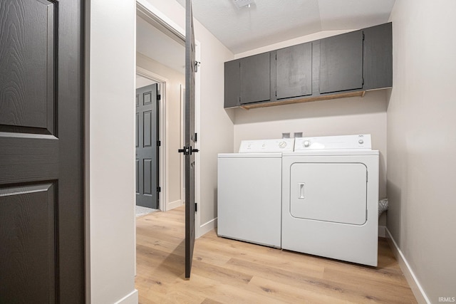 822 W Donaldson Ave, Mishawaka, IN 46545 - washroom featuring cabinet space, independent washer and dryer, and light wood-type flooring