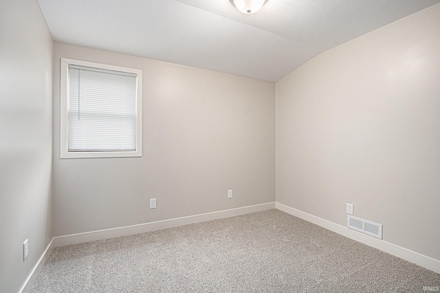 822 W Donaldson Ave, Mishawaka, IN 46545 - spare room featuring carpet and vaulted ceiling