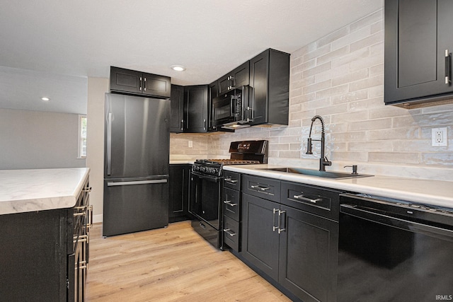 822 W Donaldson Ave, Mishawaka, IN 46545 - kitchen featuring black appliances, light countertops, dark cabinets, tasteful backsplash, and recessed lighting