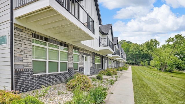 420 Catherwood Dr Unit 3, West Lafayette, IN 47906 - view of home's exterior with a balcony, board and batten siding, and a yard