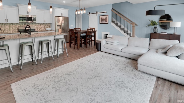 420 Catherwood Dr Unit 3, West Lafayette, IN 47906 - living area featuring light wood finished floors, recessed lighting, a barn door, and stairway