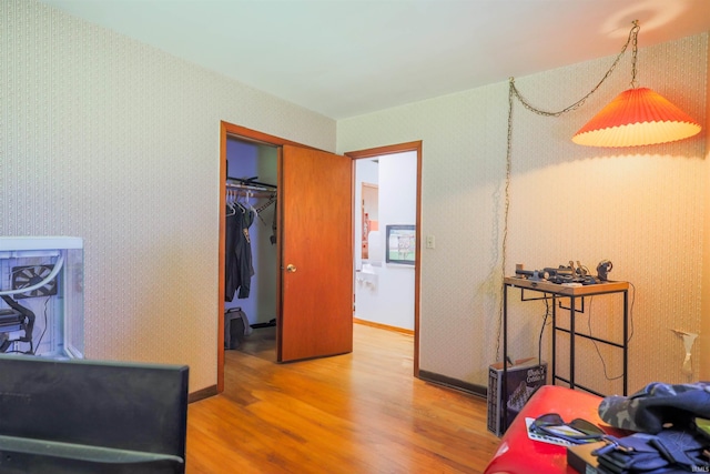 335 E State Road 58, Bedford, IN 47421 - bedroom with wood finished floors, wallpapered walls, and a closet