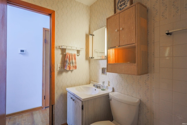 335 E State Road 58, Bedford, IN 47421 - half bathroom with wallpapered walls, vanity, and wood finished floors