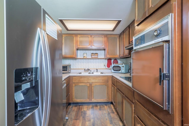 335 E State Road 58, Bedford, IN 47421 - kitchen with stainless steel refrigerator with ice dispenser, oven, light countertops, dark wood finished floors, and white microwave