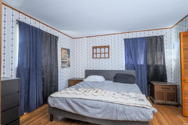 335 E State Road 58, Bedford, IN 47421 - bedroom featuring wallpapered walls, wood finished floors, and crown molding