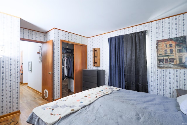335 E State Road 58, Bedford, IN 47421 - bedroom featuring ornamental molding, wallpapered walls, a closet, and wood finished floors
