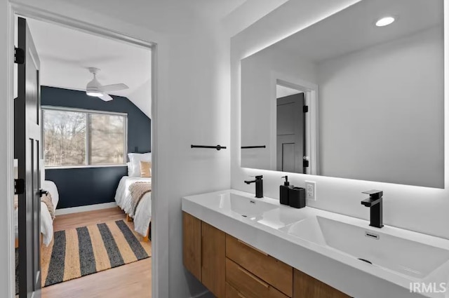 52354 Forestbrook Ave, South Bend, IN 46637 - ensuite bathroom featuring wood finished floors, double vanity, lofted ceiling, and ceiling fan