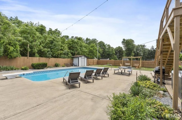 52354 Forestbrook Ave, South Bend, IN 46637 - view of pool featuring a storage shed, a patio area, a fenced backyard, and stairway