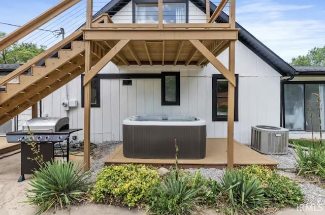 52354 Forestbrook Ave, South Bend, IN 46637 - rear view of house featuring a hot tub, a deck, stairs, and board and batten siding