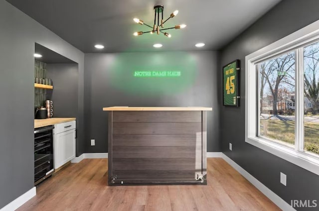 52354 Forestbrook Ave, South Bend, IN 46637 - indoor dry bar with wine cooler, light wood-style flooring, a chandelier, and recessed lighting