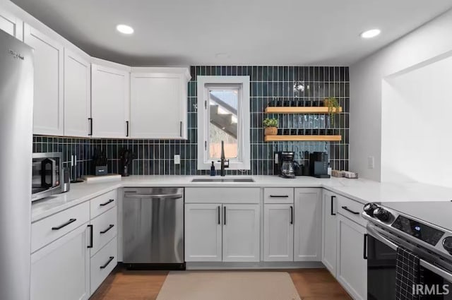 52354 Forestbrook Ave, South Bend, IN 46637 - kitchen featuring stainless steel appliances, tasteful backsplash, white cabinets, light countertops, and recessed lighting
