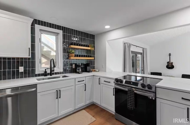 52354 Forestbrook Ave, South Bend, IN 46637 - kitchen featuring stainless steel appliances, backsplash, light countertops, open shelves, and recessed lighting