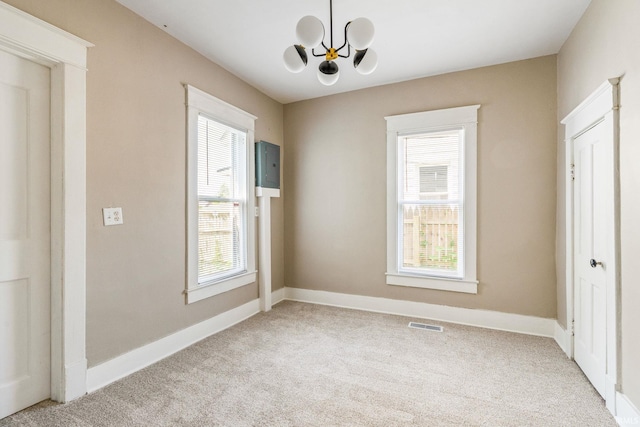 1114 W Monroe St, Kokomo, IN 46901 - unfurnished bedroom featuring light carpet, a chandelier, and multiple windows